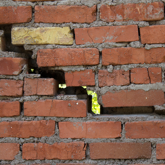 cracking brick wall
